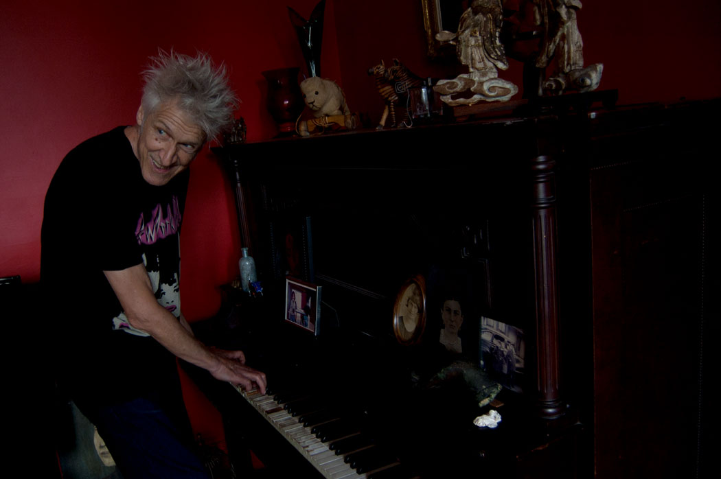 Boston rock/punk legend Willie "Loco" Alexander plays piano in the living room of his Gloucester home, July 15, 2017. (Greg Cook)