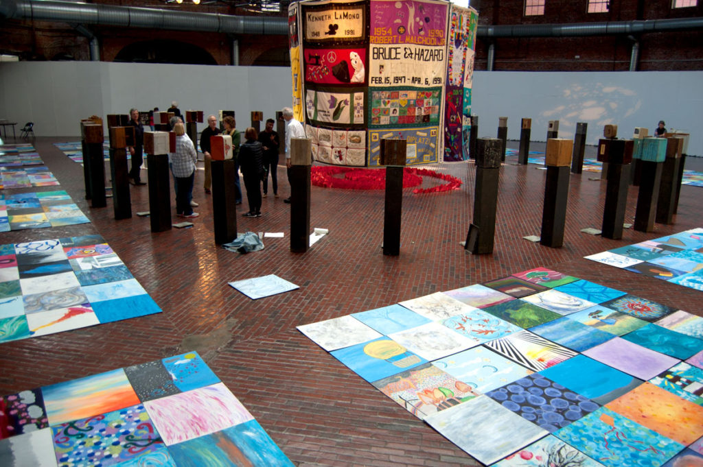 Names Project AIDS Memorial Quilt panels hang suspended at the center of "Medicine Wheel" at Boston Center for the Arts Cyclorama, Dec. 1, 2017. (Greg Cook)