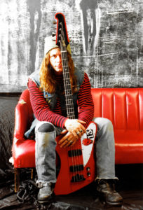 Tim Catz with his beloved red Gibson Thunderbird bass in the early 1990s. (Courtesy Tim Catz)
