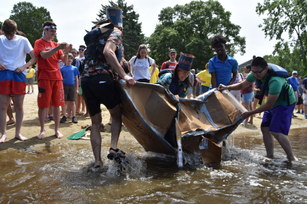 Hauling out the soggy remains of the S.S. Nork during the Cardboard Canoe Races at at Wright's Pond in Medford, June 10, 2018. (Greg Cook)