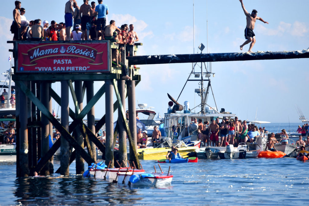 To win the Greasy Pole contest, walkers must make it to the end of a grease-slathered telephone pole to grab a flag off the end, June 29, 2018. (Greg Cook)