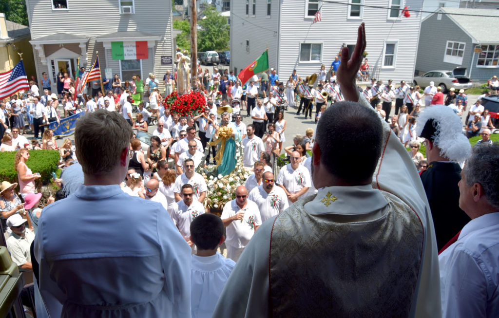 Father Jim Achadinha gives blessings at St. Ann Church during Sunday's procession, July 1, 2018. (Greg Cook)