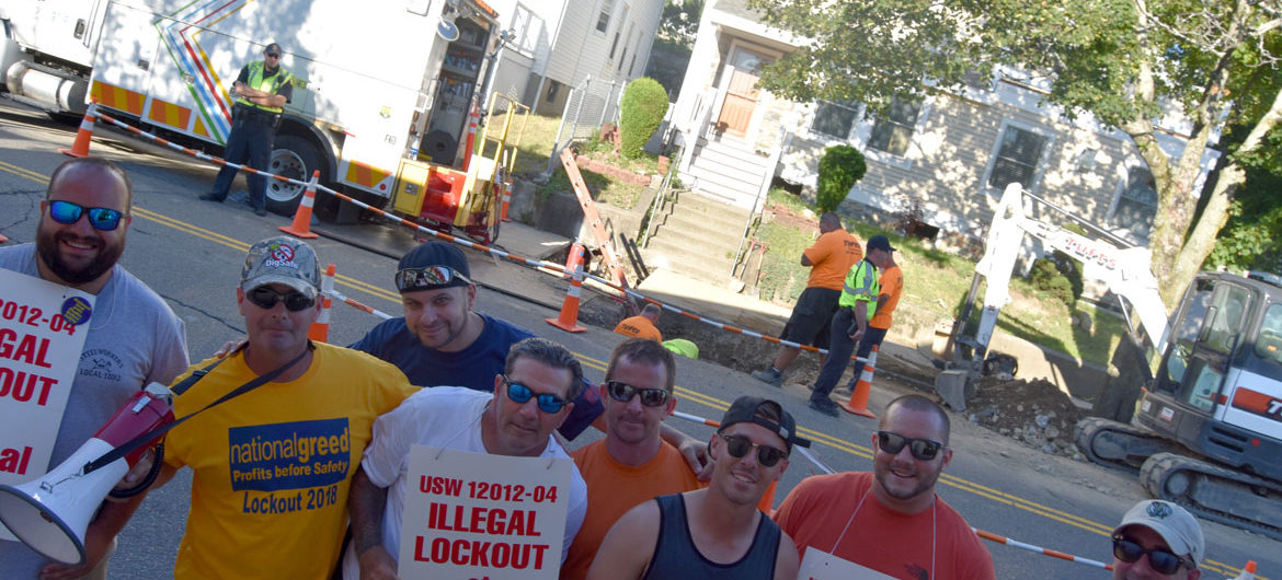 Gas workers, locked-out by National Grid in a contract dispute, protested at a company work site on Main Street in Malden, July 19, 2018. (Greg Cook)
