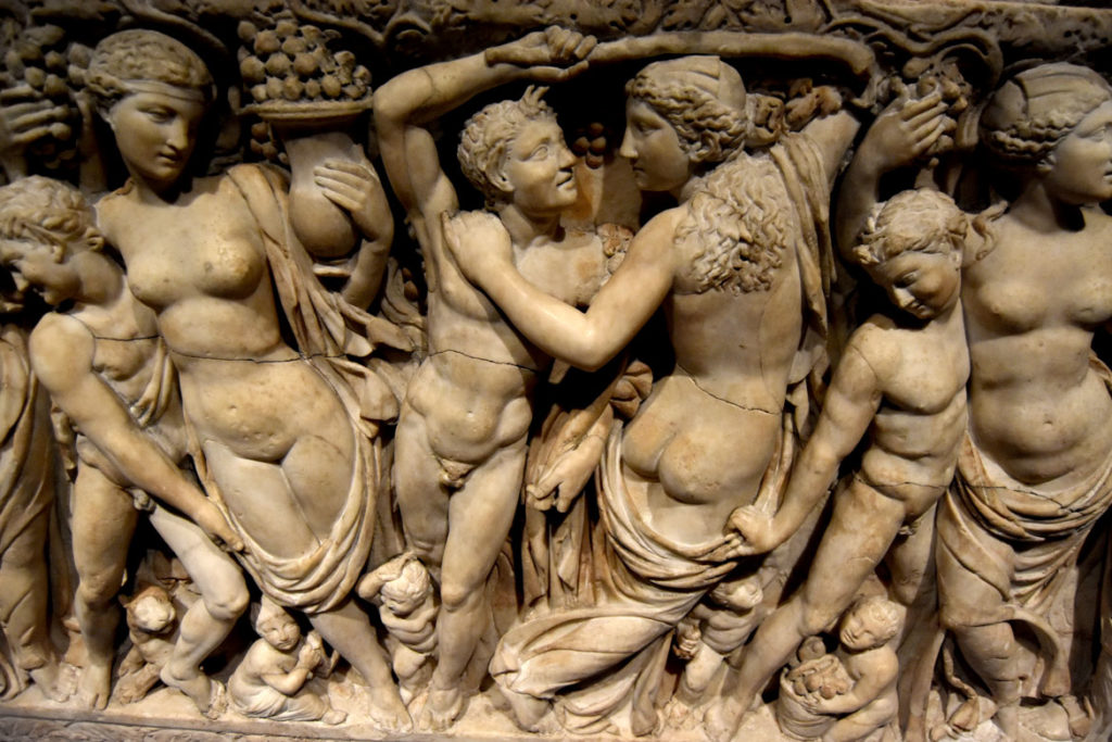 Across the front of the Gardner Museum's Farnese Sarcophagus, female worshipers of Dionysus, known as maenads, harvest grapes while lusty male satyrs strip them out of their clothes. (Greg Cook)