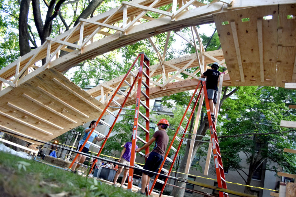 Constructing the temporary bridge spanning the courtyard of Massachusetts Institute of Technology’s East Campus residence hall, Cambridge, Aug. 28, 2018. (Greg Cook)