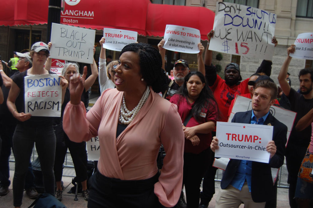 “How dare he say he wants to make American great again,” Boston City Councilor Ayanna Pressley said, “when he wants to vilify the people who built it.” At protest of Donald Trump at Langham Hotel in Boston, June 29, 2016. (Greg Cook)