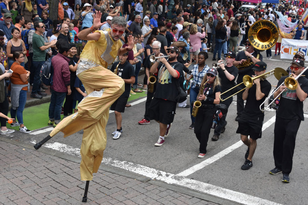Shawn Morrissey stilts with the Dirty Water Brass Band from Boston in the Honk Parade, Oct. 7, 2018. (Greg Cook)