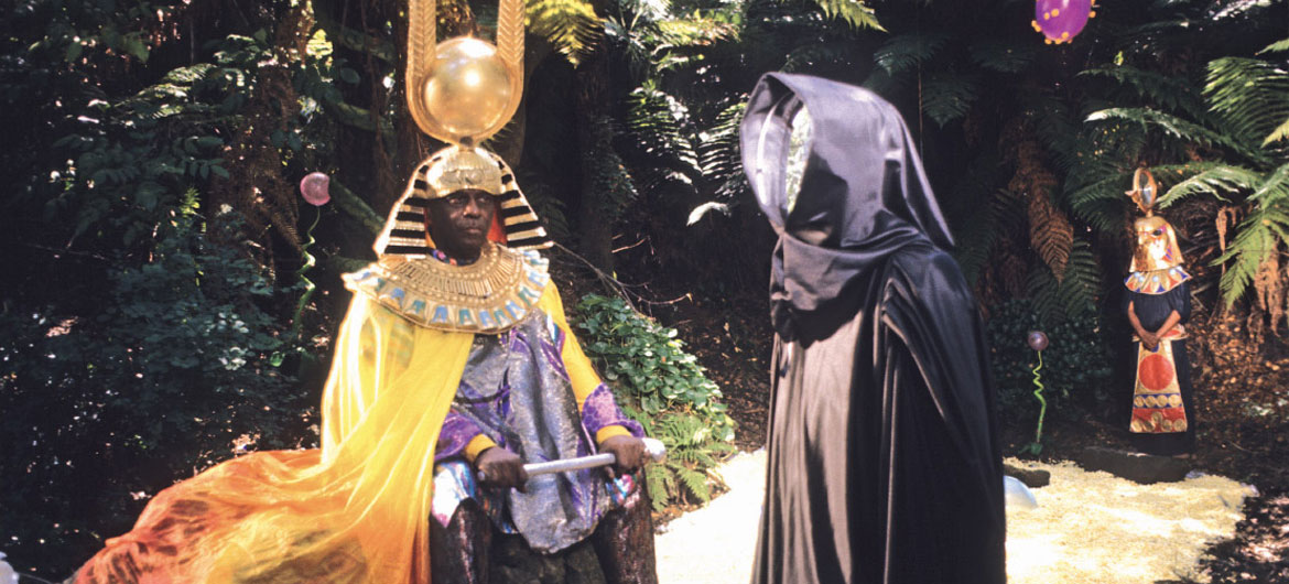 “Space is the Place Film Still,” 1974, by Jim Newman. “Sun Ra and his mysterious mirror-faced companion in Golden Gate Park. The photo is from the opening sequence of the film in which Sun Ra wanders a lush unspecified planet and outlines his theory on how we can move through space propelled by music, a theoretical way of travel he calls ‘trans-molecularization.’” (Courtesy Portland Art Museum)