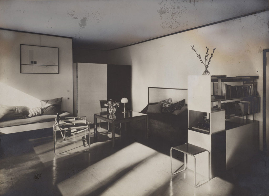 At Harvard Art Museums: Lucia Moholy, "Bauhaus Masters Housing, Dessau (Lucia Moholy and László Moholy-Nagy's living room)," 1927–28. Gelatin silver print with opaque watercolor retouching. (Harvard Art Museums/Busch-Reisinger Museum)