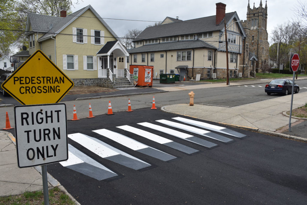 Optical illusion crosswalk painted by Nate Swain at Medford’s Brooks Elementary School, April 20, 2019. (Greg Cook)