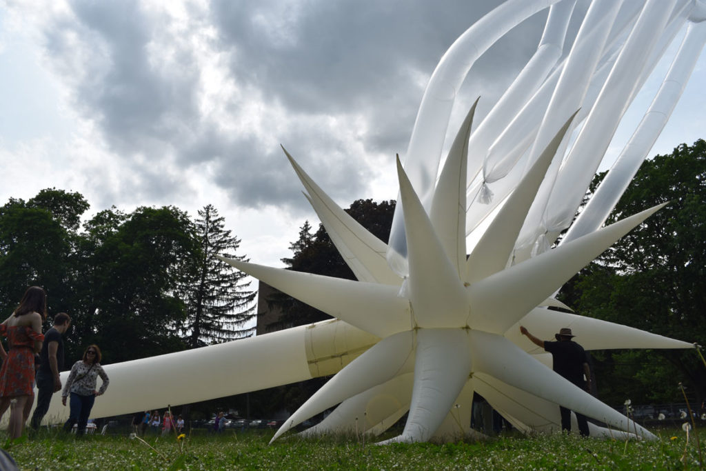 Attaching helium-filled tubes to Otto Piene's "Sky Art" inflatable sculpture "Paris Star" at the Fitchburg Art Museum, June 2, 2019. (Greg Cook)
