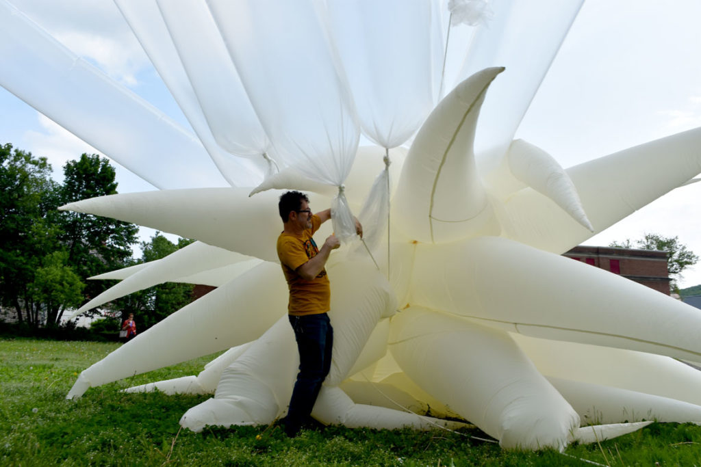 Attaching helium-filled tubes to Otto Piene's "Sky Art" inflatable sculpture "Paris Star" at the Fitchburg Art Museum, June 2, 2019. (Greg Cook)
