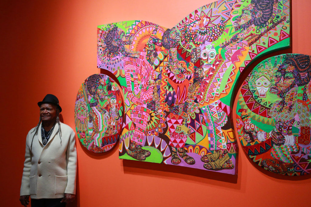 Wadsworth Jarrell with his 1974 painting "Prophecy" in the exhibition "AFricCOBRA: Messages to the People" at the Museum of Contemporary Art, North Miami, 2018 to 2019. (WorldRedEye.com)