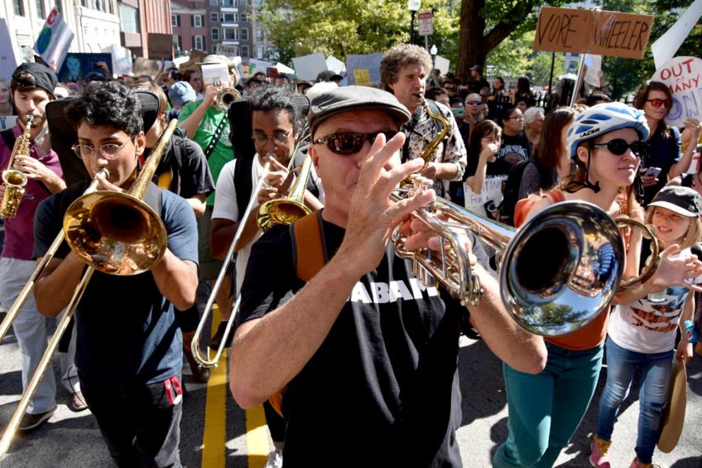 Babam plays at the Boston Climate Strike, on Park Street heading to the Massachusetts State House, Sept. 20, 2019. (Greg Cook)