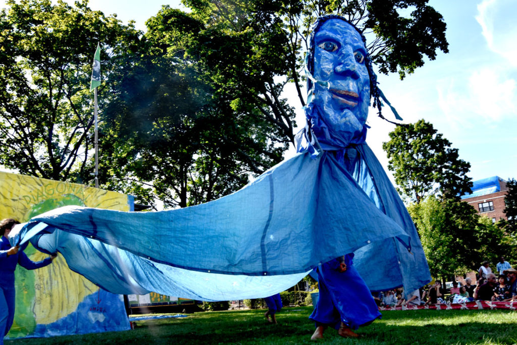 A giant water puppet during Bread and Puppet Theater's "Diagonal Life Circus" at Cambridge Common, Aug. 31, 2019. (Greg Cook)