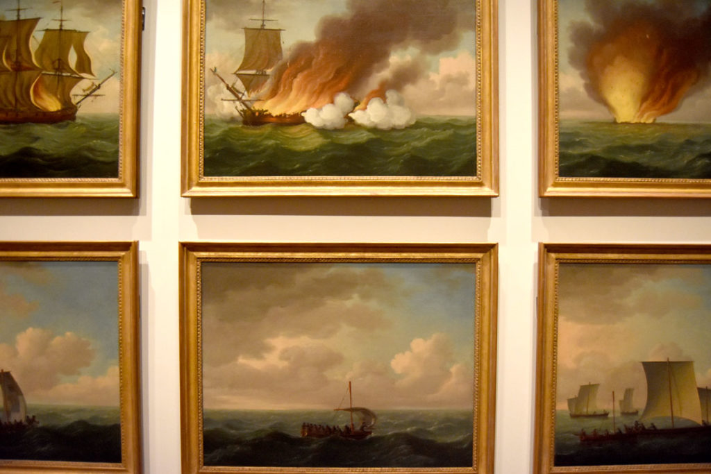 “The Burning of the Luxborough Gallery” painted by John Cleveley the Elder, 1759. Recounting the story of a slave ship that caught fire and exploded in 1727, killing 16 crewmembers. Twenty-three survivors turned to cannibalism. Displayed in the maritime galleries of the Peabody Essex Museum's new wing, Salem, Sept. 25, 2019. (Greg Cook photo)