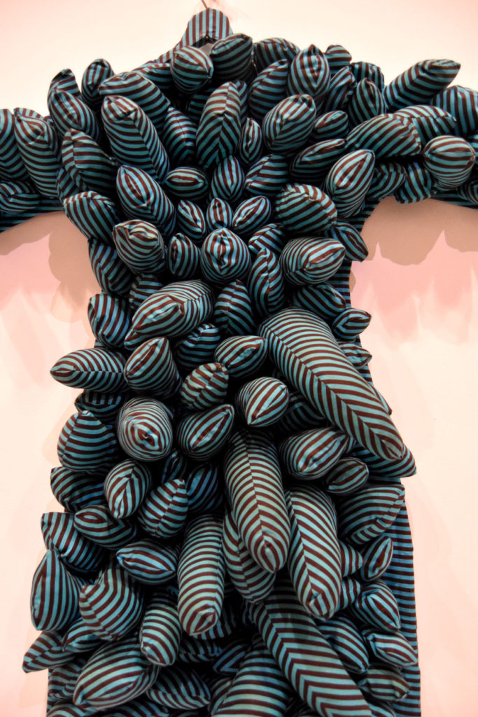 Yayoi Kusama, "Blue Coat," 1965, stuffed and sewn aqua and black striped cotton, wire hanger.