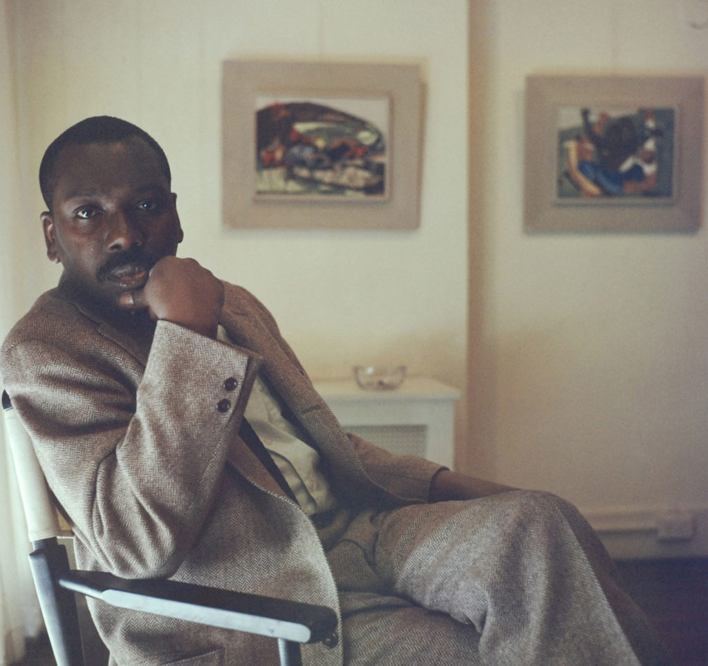 Artist Jacob Lawrence with panels 26 and 27 from ​"Struggle: From the History of the American People​," 1954–56. (© Robert W. Kelley/The LIFE Picture Collection/Getty Images)
