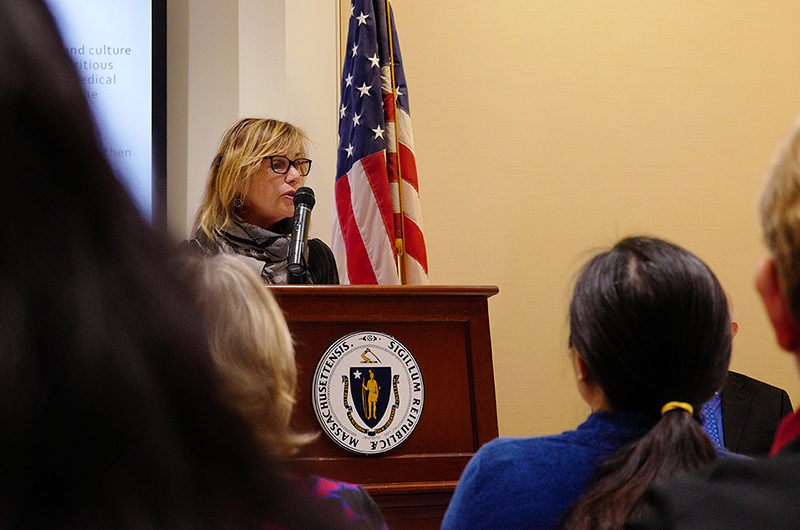 Anita Walker speaking at a podium at the State House. (Photo: Mass Cultural Council / Timothea Pham)