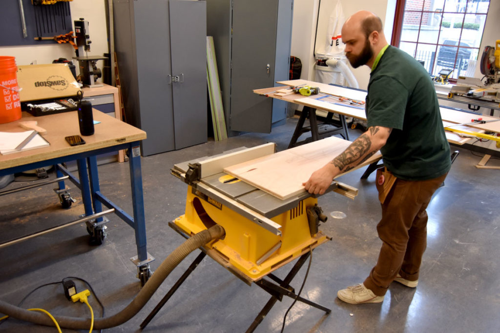 Carpenter Andrew Thompson works in the MassArt Art Museum's renovated and expanded art preparatory workshop, Feb. 25, 2020. (Greg Cook)