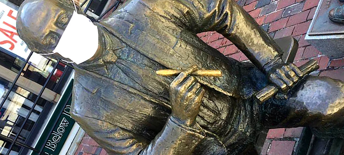 A protective mask has appeared on the 1985 statue of longtime Boston Celtics coach Red Auerbach by Lloyd Lillie outside Quincy Market at Faneuil Hall, c. April 6, 2020. (Courtesy)