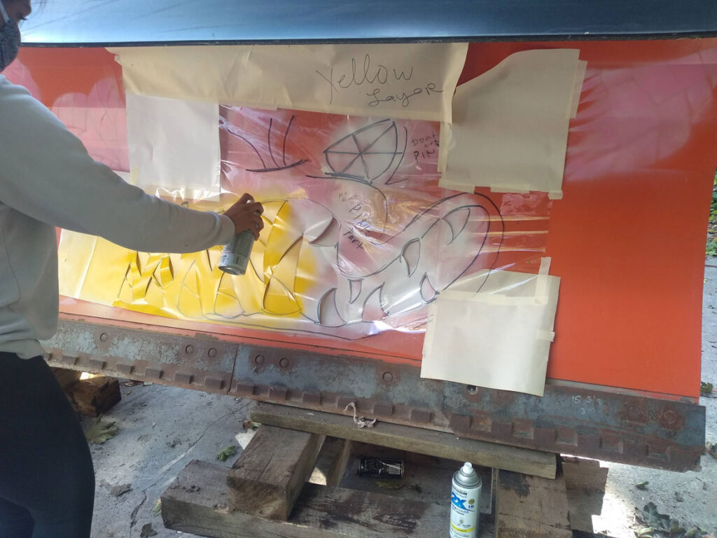 Spraypainting the "Batbeast" snowplow design by Rhonda Ratray with help from her art students from Vermont School for Girls for the North Bennington, Vermont, highway department, fall 2020. (Courtesy Rhonda Ratray)
