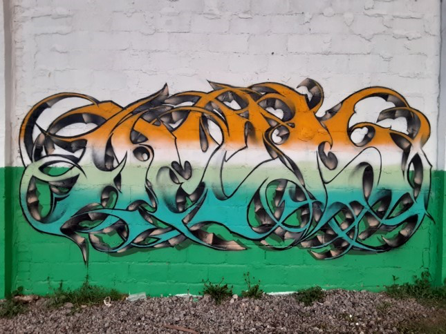 Art by Apeks created at the “Back Against the Wall: Graffiti in Grove Hall” event at Moses Auto in Boston's Dorchester neighborhood on May 15, 2021. (Courtesy Sobek)