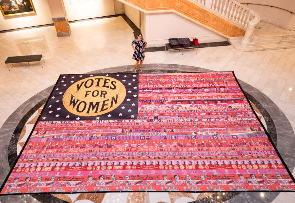 “Her Flag” created by Oklahoma artist Marilyn Artus (pictured) and collaborators on view at the National Museum of Women in the Arts, Washington, D.C., June 2021. (Courtesy National Museum of Women in the Art / Kevin Allen photo)