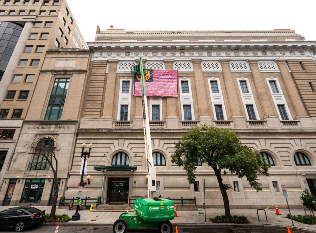 “Her Flag” created by Oklahoma artist Marilyn Artus and collaborators being installed at the National Museum of Women in the Arts, Washington, D.C., June 2021. (Courtesy National Museum of Women in the Art / Kevin Allen photo)