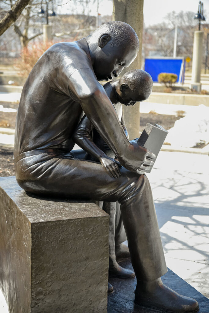 John Wilson's sculpture "Father and Child Reading," 1990, at Roxbury Community College, Boston. (Courtesy Roxbury Community College)