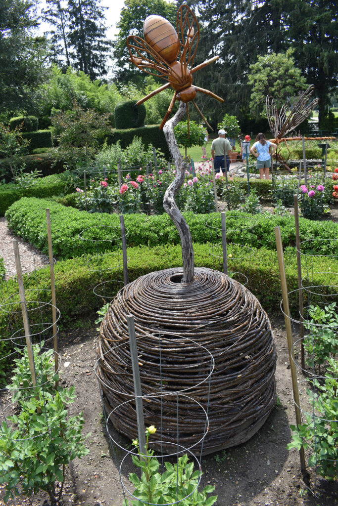 "Bee and Skep" by David Rogers in "Big Bugs" at Green Animals Topiary Garden, Portsmouth, Rhode Island, August 2021. (©Greg Cook photo)