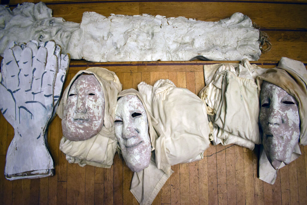 Masks and props backstage before Bread and Puppet Theater performs "Finished Waiting" at First Church in Cambridge, March 22, 2022. (©Greg Cook photo)