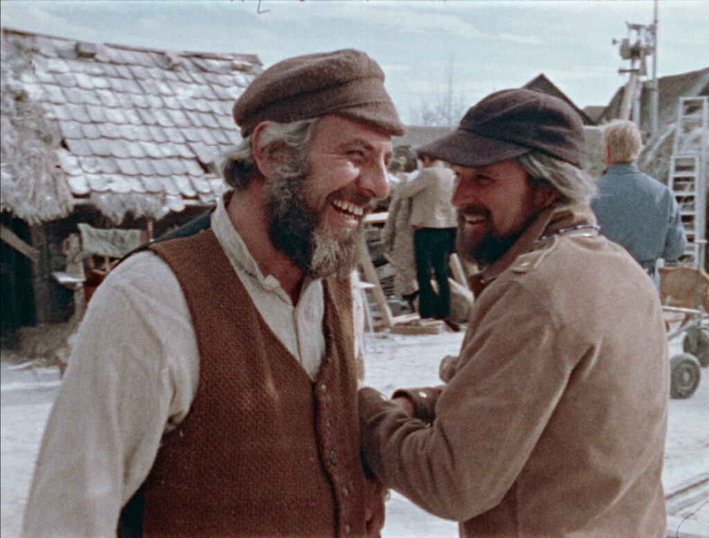 Topol, as Tevye (left) and director Norman Jewison working on the 1971 film "Fiddler on the Roof," as seen in the 2021 documentary “Fiddler’s Journey to the Big Screen."