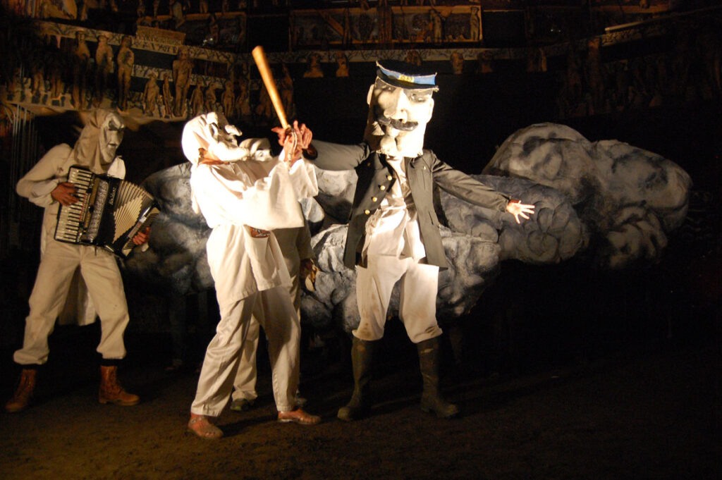 Genevieve Yeuillaz (masked,second from left) performs in Bread and Puppet's “The Seditious Conspiracy Theater Presents: A Monument to the Political Prisoner Oscar Lopez Rivera," Glover, Vermont, Aug. 22, 2015. (©Greg Cook photo)