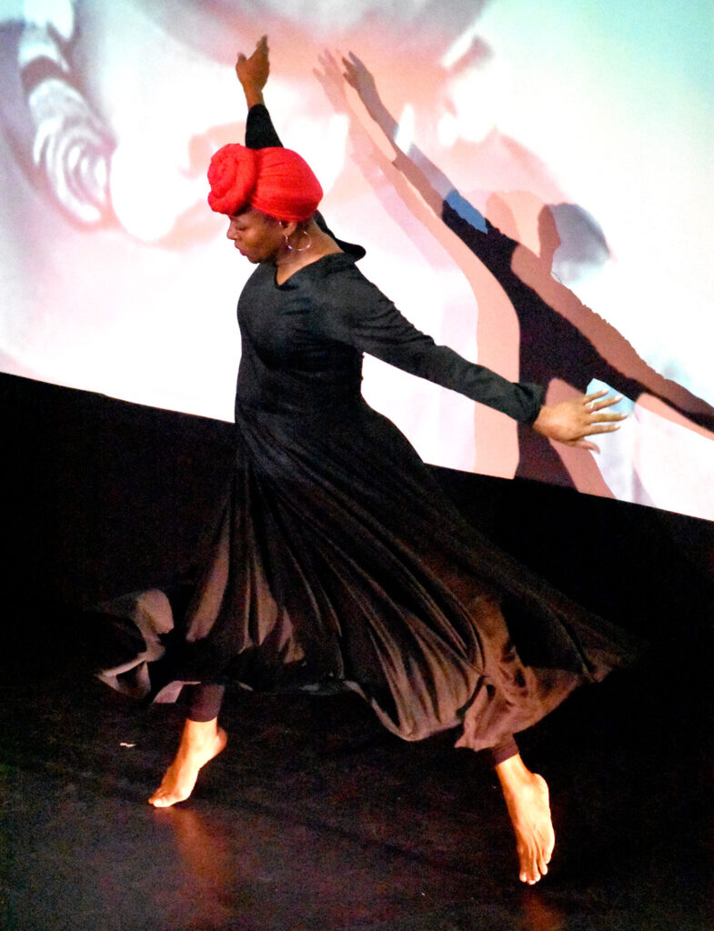 Lisa Miller-Gillespie dances at the Arts & Culture Summit from the Essex County Community Foundation's Creative County Initiative at The Cabot theater in Beverly, Sept. 30, 2022. (©Greg Cook photo)