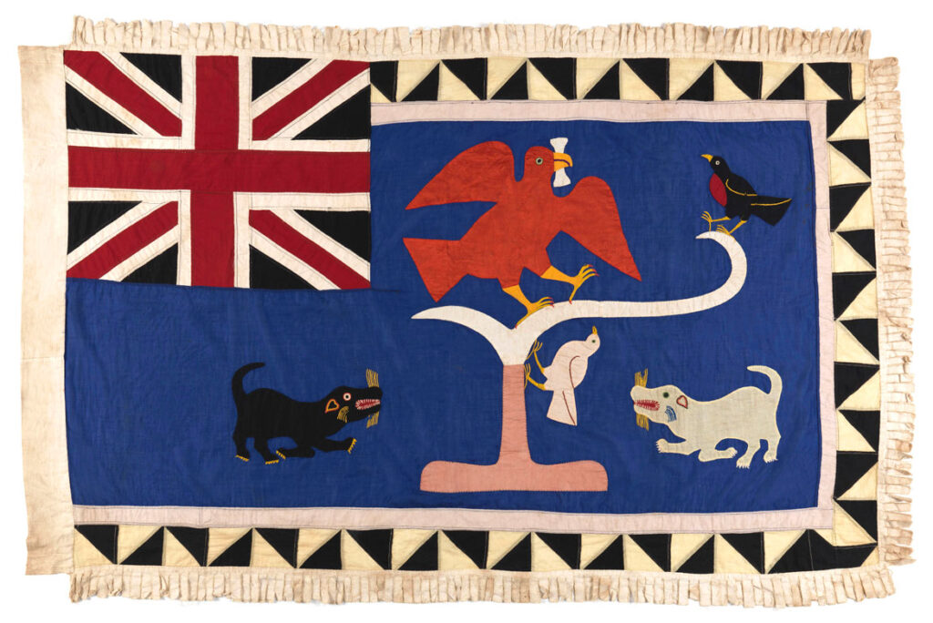 Kweku Kakanu, Saltpond workshop, Dentsir No. 2 Company Lowtown, c. 1950; cotton. In this flag, the eagle with a bone in its beak references sayings related to territorial disputes and issues related to the ownership of places and things, including the motifs on flags and posuban. The specific saying is, “If the Eagle gets the bone, it is for nothing. It belongs to the dog.” The eagle may take the bone, as another company may take a motif, but it will always belong to the original owner.