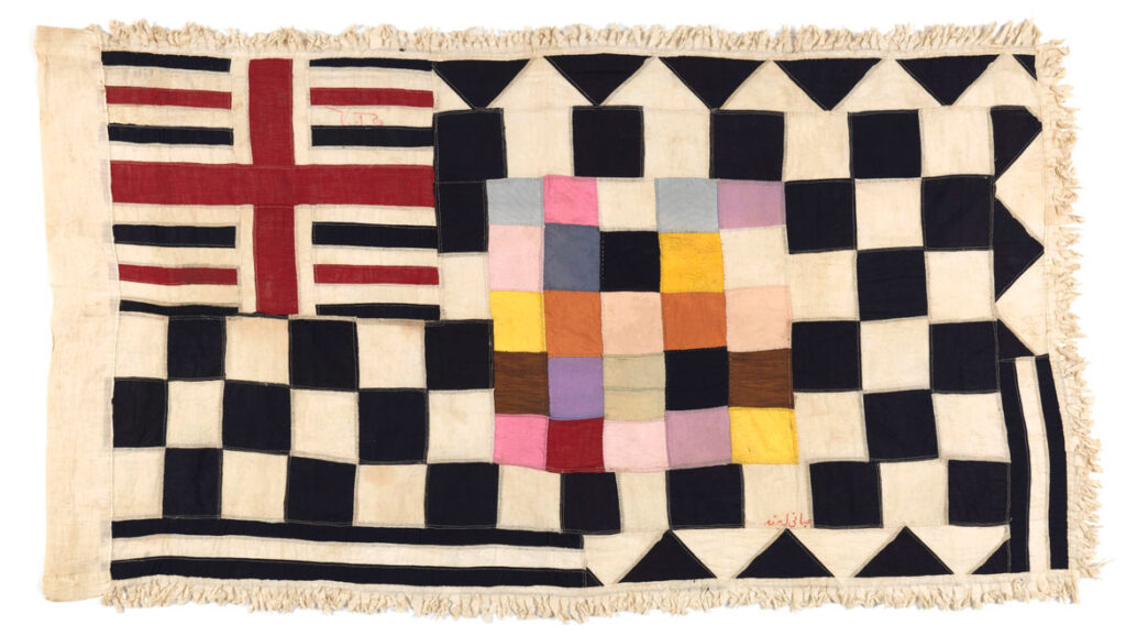 Kwaku Akyeampong, Kormantse workshop, No. 1 Company Egya, c. 1925; cotton, synthetic fabric. Draughts, called damii in the Fante language, is a common game and a frequent motif on flags. As with other competitive games, draughts is a metaphor for war and suggests a company’s readiness to engage the enemy in a “war” of draughts at any time.