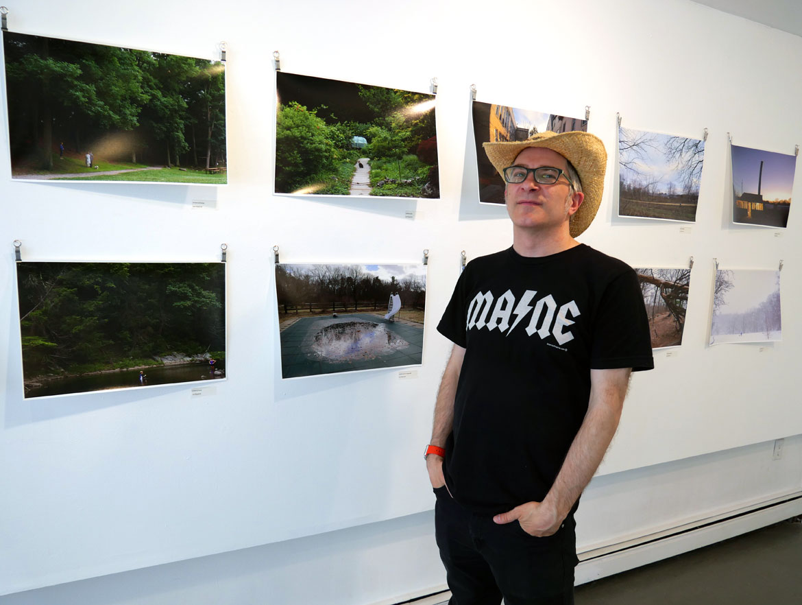 Lee Kilpatrick with his photos at Washington Street Studios during Somerville Open Studios, May 6, 2023. (©Greg Cook photo)