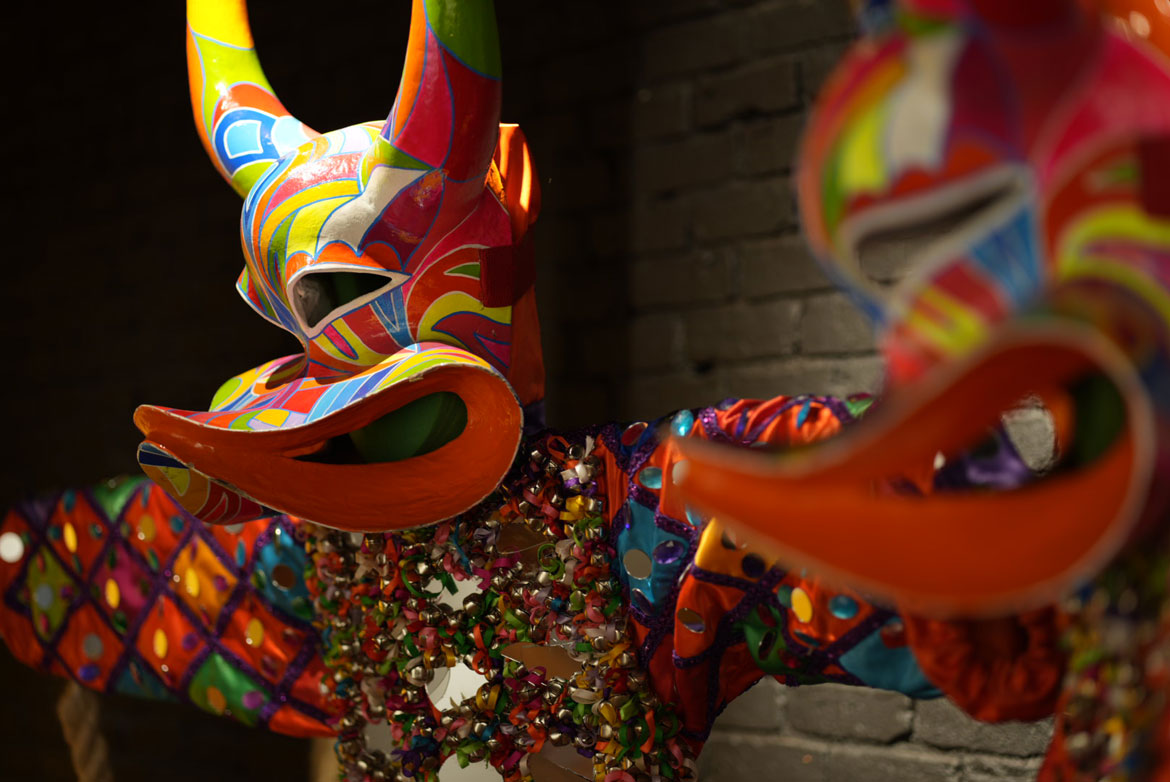 Asociacion Carnavalesca de Massachusetts masks and suits in “El Carnaval Continúa" at the Essex Art Center, Lawrence. (Mariana Martins photo)