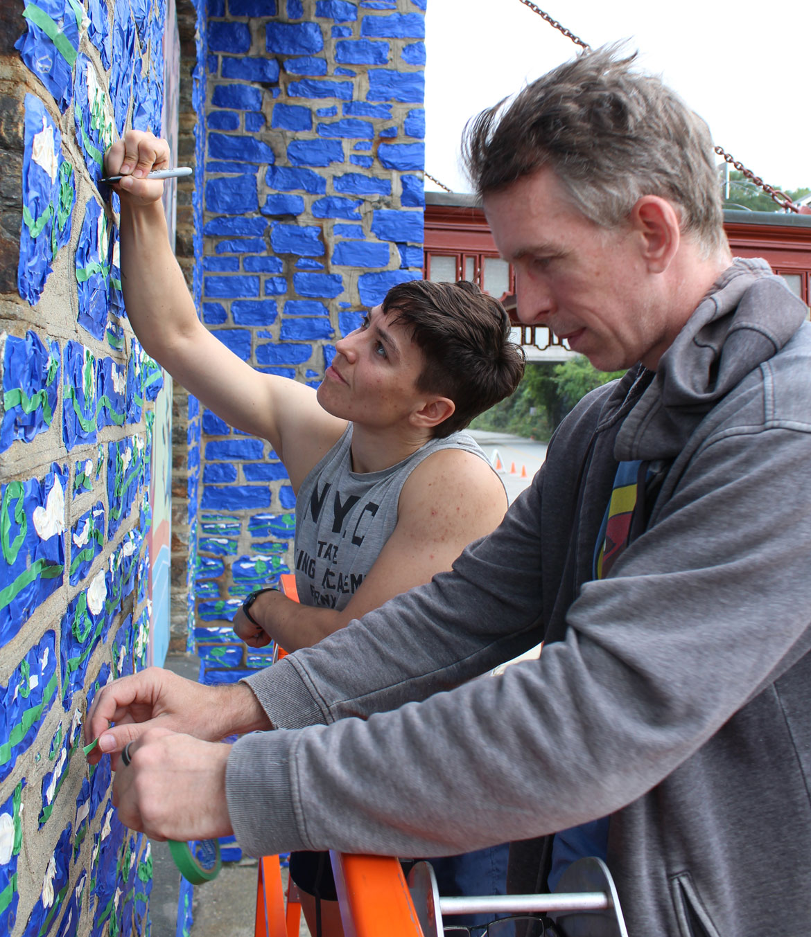 Leah Smith (left) and Michael Townsend of Tape Art work on their temporary mural on the facade of the Brattleboro Museum & Art Center in Vermont. (Photo courtesy Brattleboro Museum & Art Center)