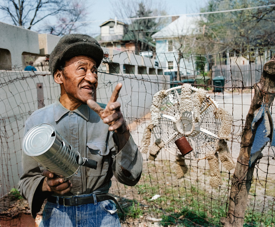 Ted Degener (American, b. 1948). Hawkins Bolden gestures while holding one of his “scarecrow” sculptures in his yard in Memphis, Tennessee, 1993. Archival pigment print. Photo courtesy Ted Degener