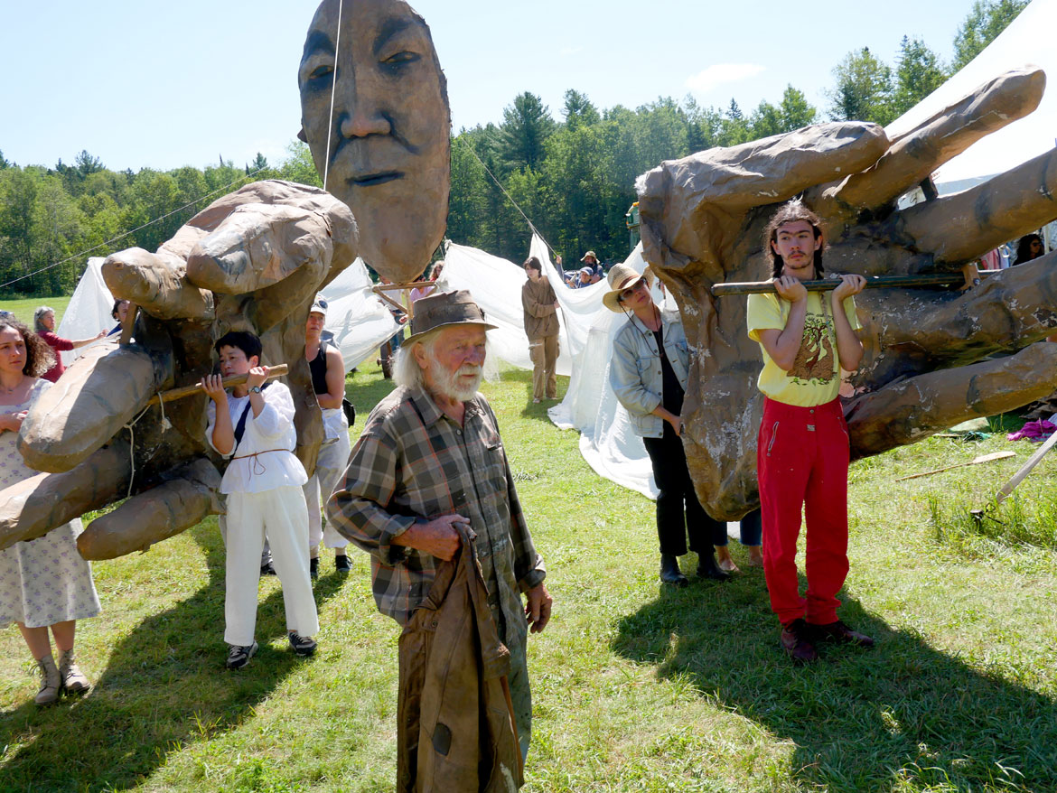 Peter Schumann (center) directing a rehearsal of the giant Mother Earth puppet for Bread and Puppet Theater's "The Heart of the Matter" Circus, Glover, Vermont, Sunday, July 30, 2023. (©Greg Cook photo)