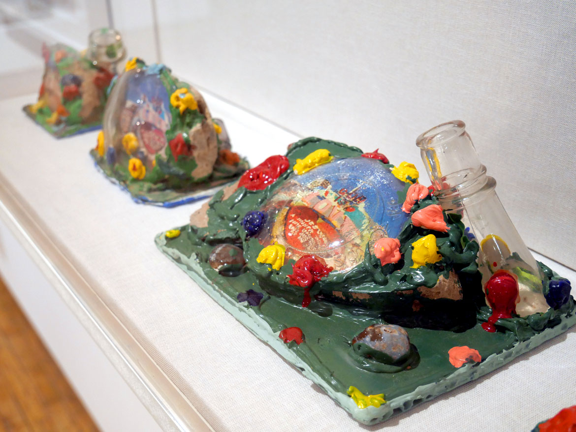 Leonard Knight, souvenirs of his Salvation Mountain, glass, paint, caulk, pumice, cactus and photo. In “Ted Degener: At Home with Artists” at Intuit in Chicago.
