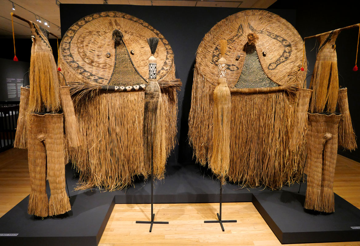 Itsautaku Waurá, Karapotan Waurá, and Aulahu Waurá, "Atujuwá Masks and Skirts," "Supukuyawa Yuluma Eneju Mask and Outfit," "Spukuyawa Yuluma Toneju Mask and Outfit," and "Pair of Yukuku Masks," 2000, buriti fiber, vine, wool thread, beeswax adhesive putty, metal, wood, annatto and genipap.