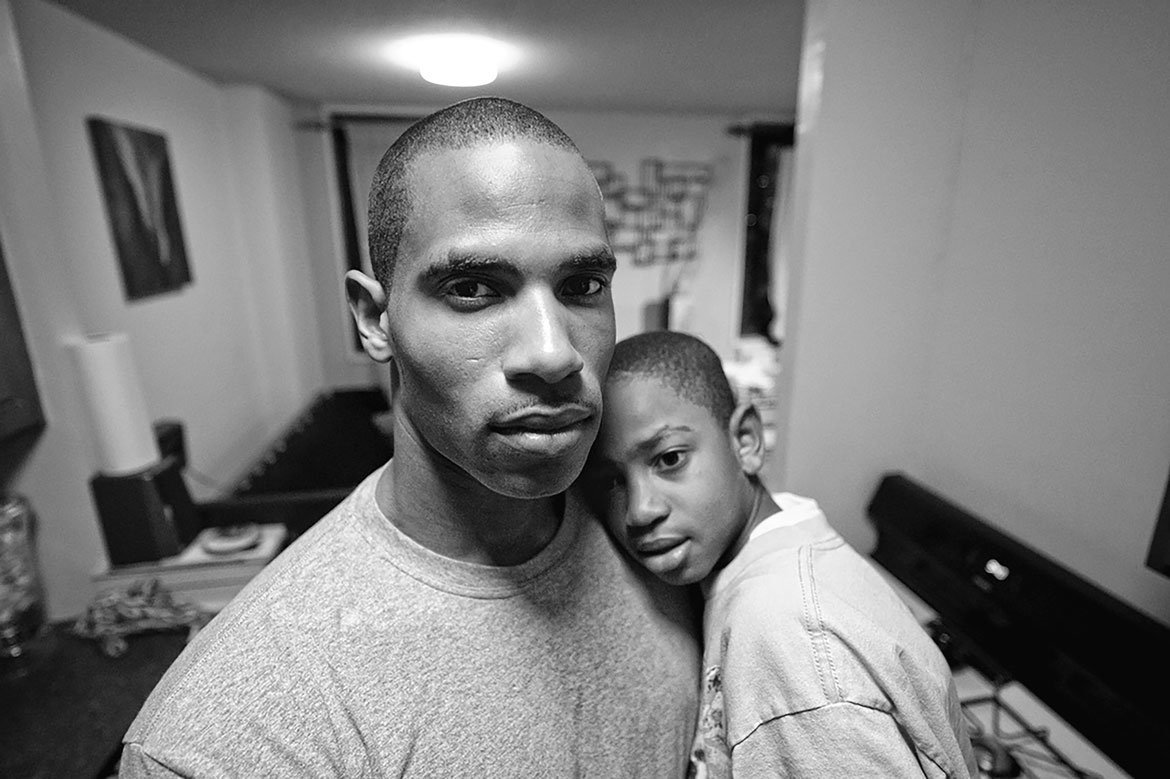 Zun Lee, "Jebron Felder and his son Jae’shaun at home, Harlem, New York," September 2011, from As We Rise: Photography from the Black Atlantic (Aperture, 2021). Courtesy Zun Lee, from the Father Figure Project.