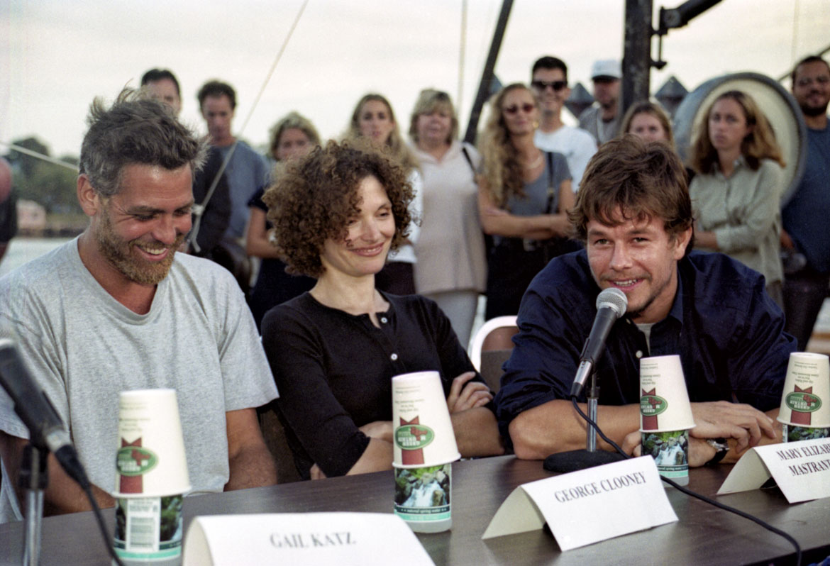 "Movie stars George Clooney, Mary Elizabeth Mastrantonio and Mark Wahlberg attend last night's press conference on the railways at Harbor Loop to kick off the filming of the Gloucester portion of 'The Perfect Storm,'" Sept. 8, 1999. Photograph by Desi Smith. In "Above the Fold" at the Cape Ann Museum, 2023.
