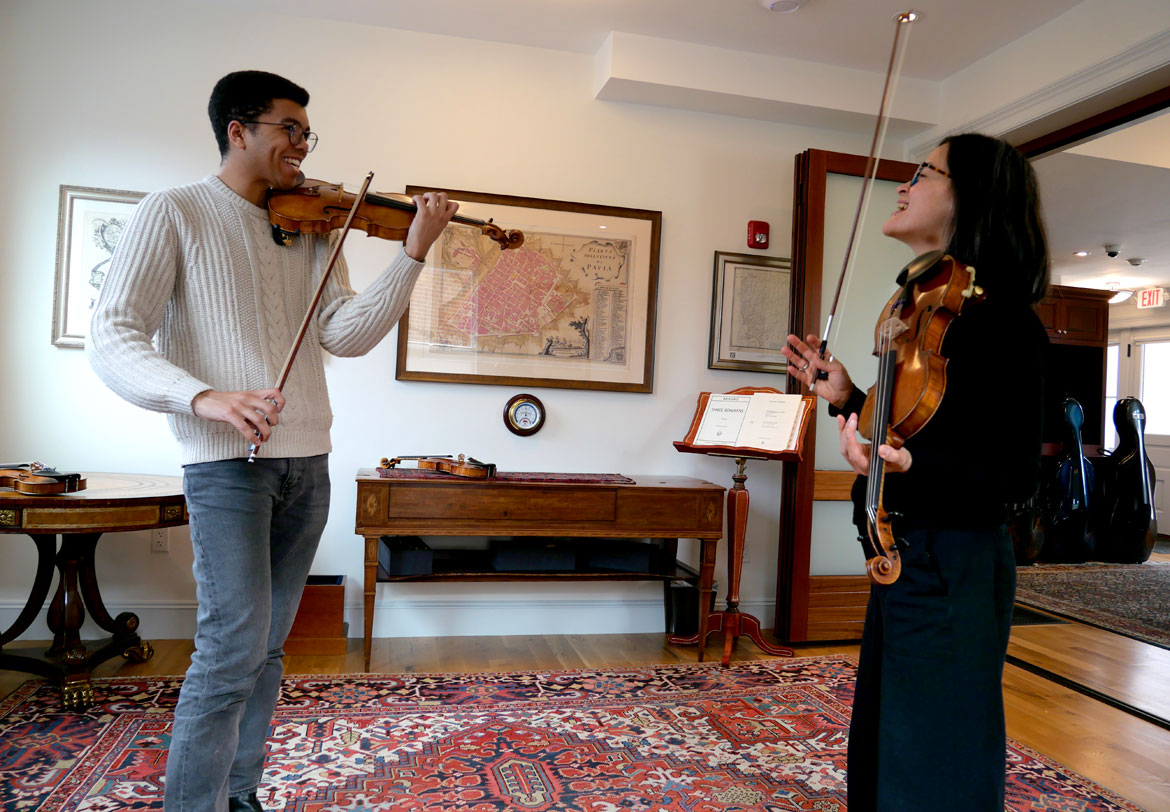 Grant Houston (left) and Megumi Stohs Lewis of A Far Cry at Reuning & Son Violins, Brookline, March 25, 2024. (©Greg Cook photo)