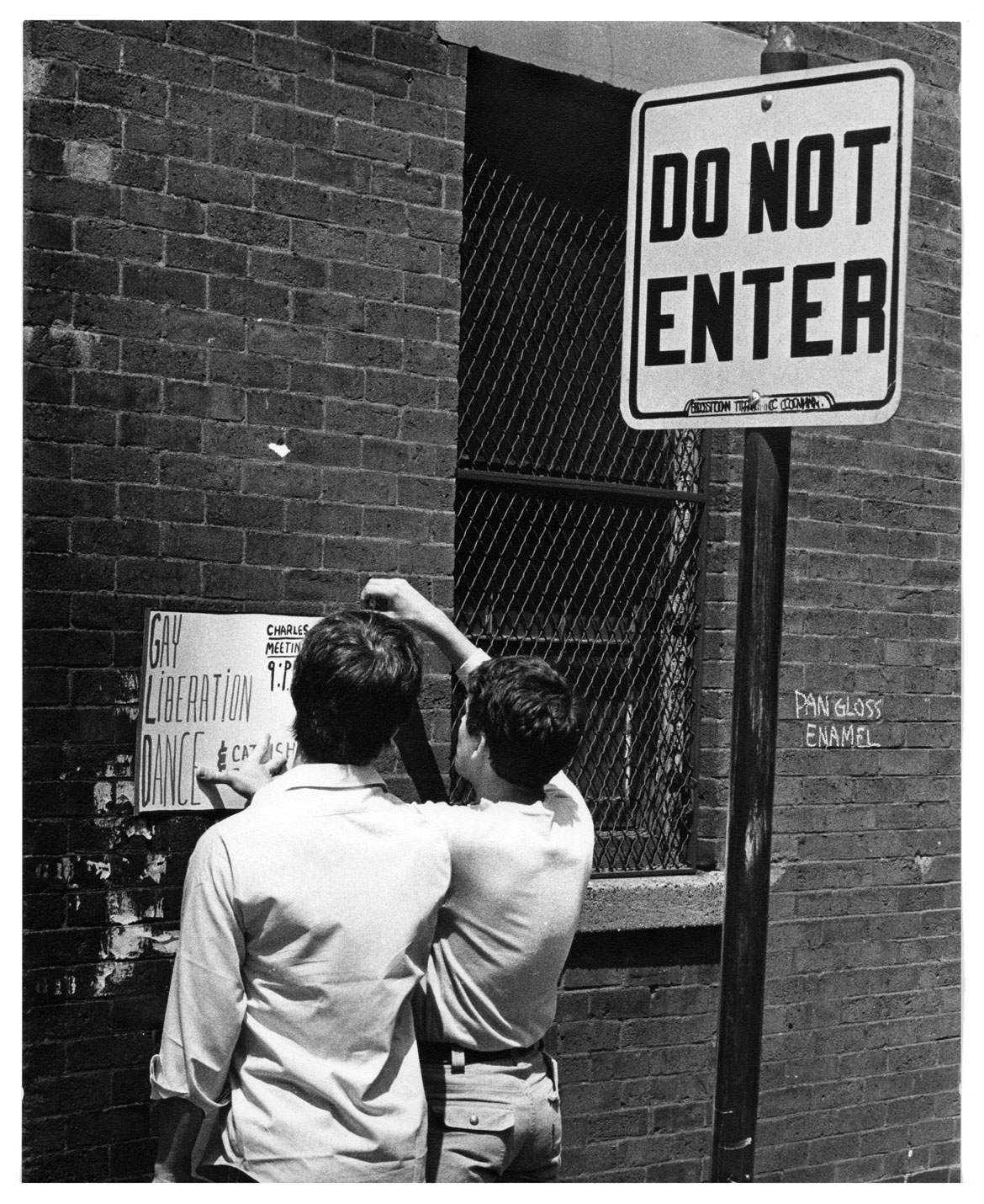 Nick DeWolf, "Young Men Hanging a Poster for Gay Liberation Dance at Charles Street Meeting House," 1970, photograph. (Courtesy of the Nick DeWolf Foundation Photo Archive)