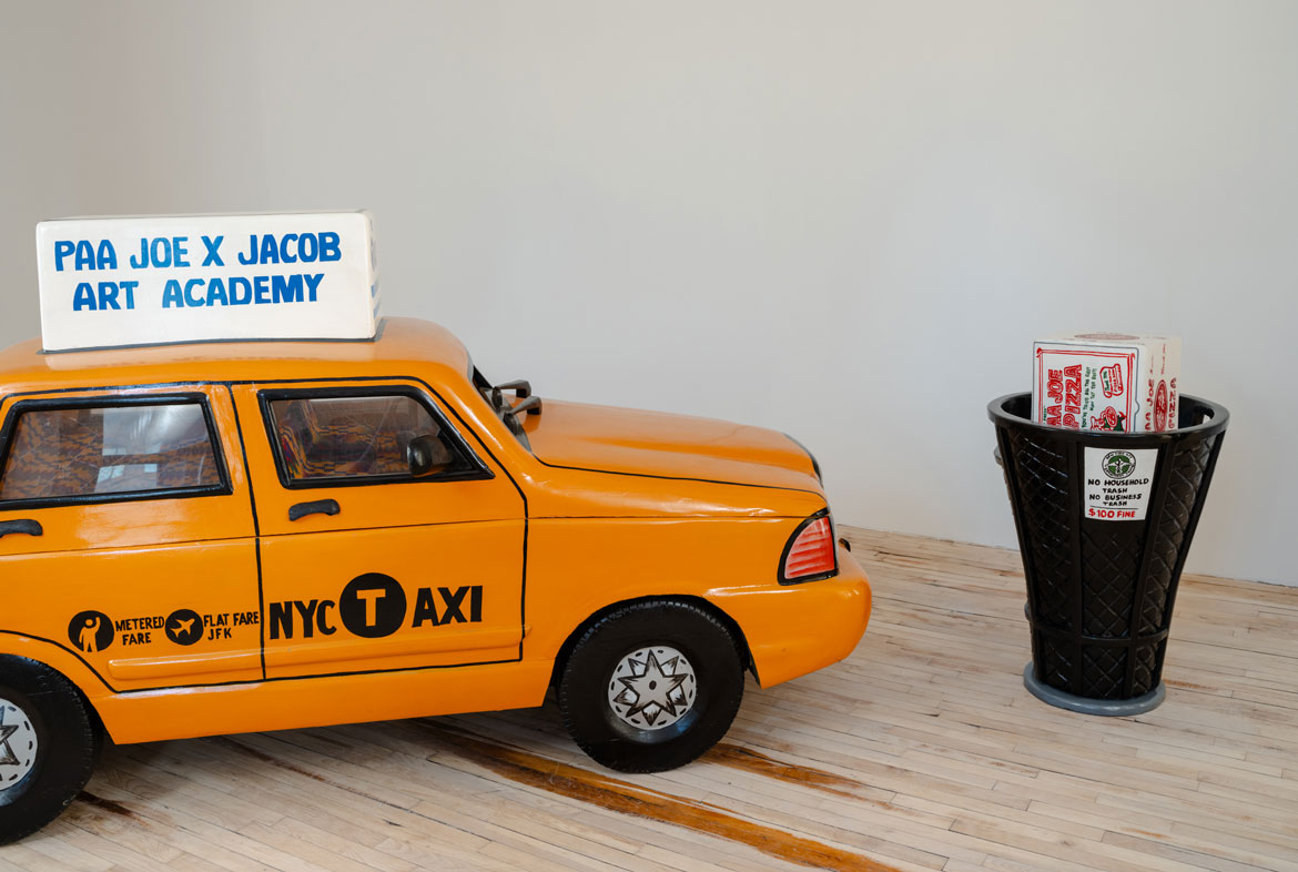 Paa Joe, "Yellow Cab," 2024, and "NYC Department of Sanitation," 2023, emele wood, enamel, cloth, acrylic. (Superhouse)