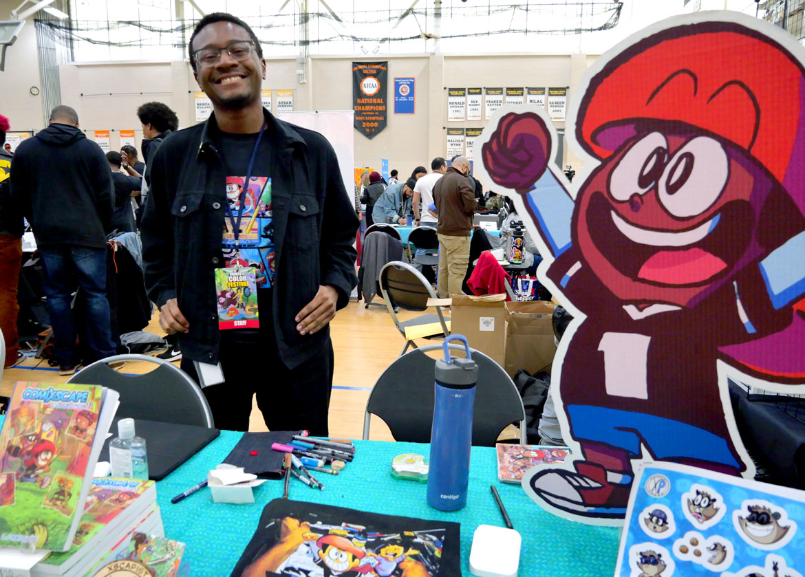 LJ Baptiste at "Boston Comics in Color Festival" at the Reggie Lewis Track and Athletic Center in Roxbury, April 20, 2024. (©Greg Cook photo)